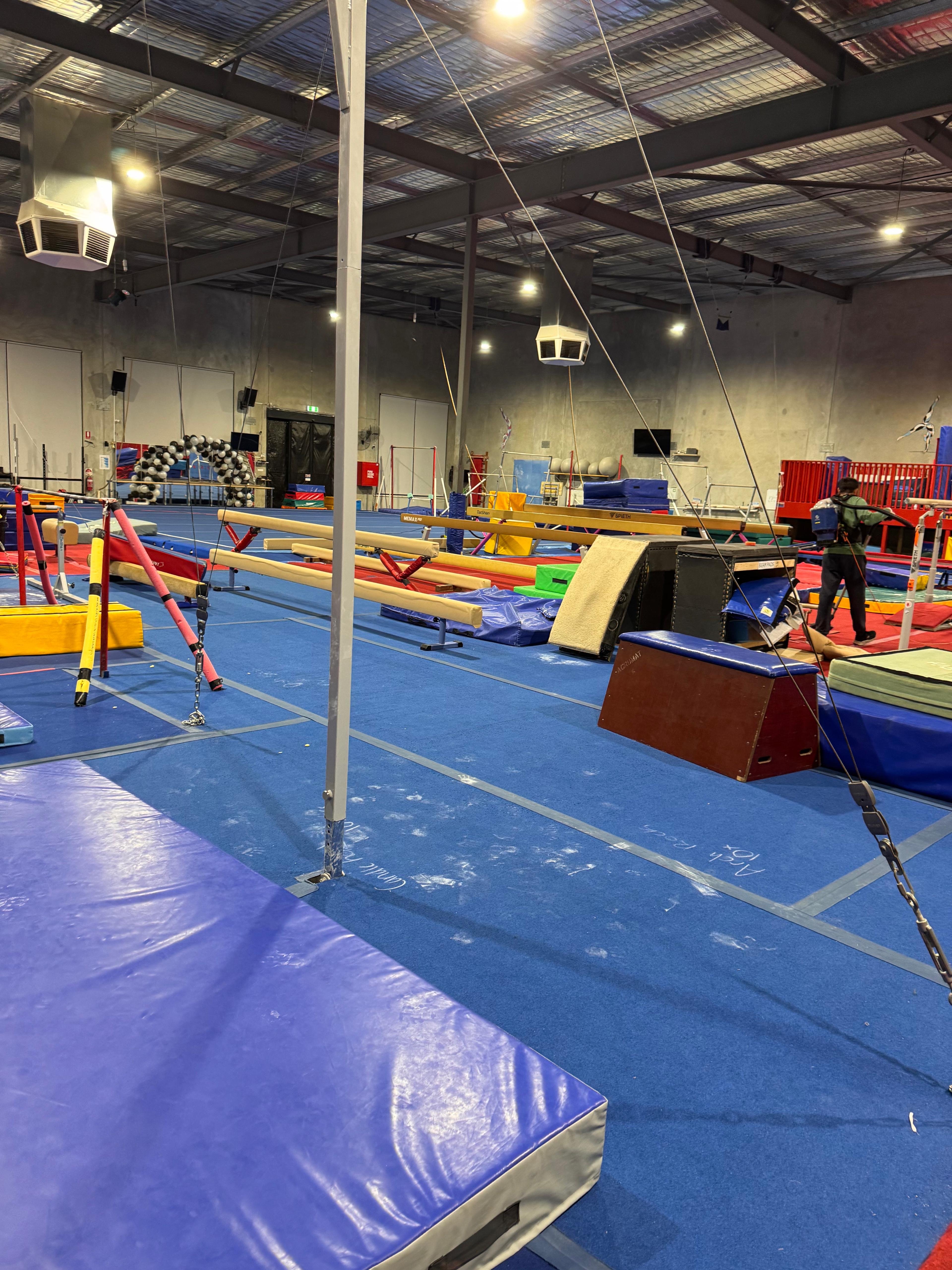Before cleaning example showing a marked gym floor in a large facility